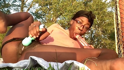 Ebony brunette with a hairy pussy riding a dildo outdoors