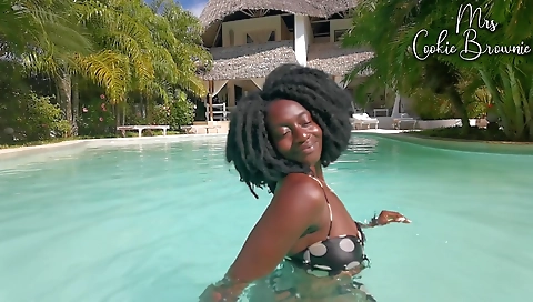 Latina brunette enjoys swimming in the pool on a bed