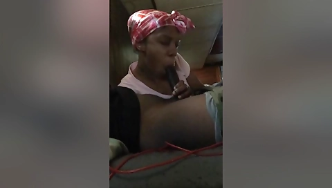 Ebony milf in black dress and stockings on bed with lover