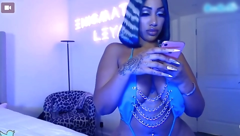 Amateur tattooed ebony babe shows off her shaved pussy